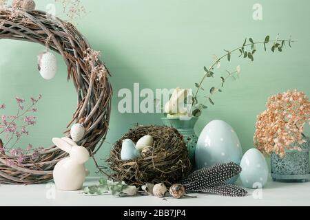 Easter ornaments in light and pastel colors with clear light, with eggs and rabbits, ornaments for the home, interior, bird nest with eggs inside Stock Photo