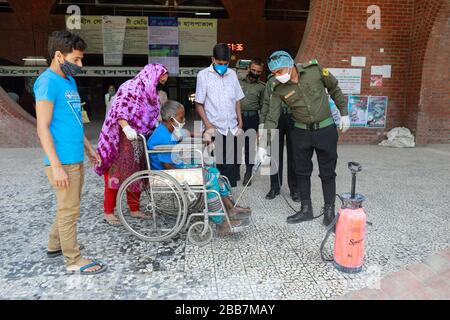 Dhaka, Bangladesh. 30th Mar, 2020. Guards disinfect Visitors and patients as they come to a hospital in Dhaka, Bangladesh, March 30, 2020. A nationwide lockdown is going on all over the country to curb the spread of the novel coronavirus in the wake of five deaths and at least 49 infections. Credit: Suvra Kanti Das/ZUMA Wire/Alamy Live News Stock Photo