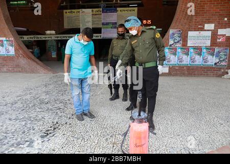Dhaka, Bangladesh. 30th Mar, 2020. Guards disinfect Visitors and patients as they come to a hospital in Dhaka, Bangladesh, March 30, 2020. A nationwide lockdown is going on all over the country to curb the spread of the novel coronavirus in the wake of five deaths and at least 49 infections. Credit: Suvra Kanti Das/ZUMA Wire/Alamy Live News Stock Photo