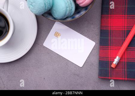 credit card with tea and notepad on table Stock Photo