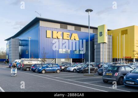 MILTON KEYNES, UK - February 12, 2020. Outside an Ikea store in Milton Keynes, with shopper, cars and car park in the foreground Stock Photo