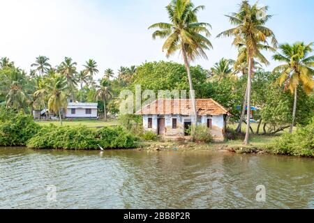 Kerala, India - March 31, 2018: Old derelict small house on backwaters. Taken on a sunny spring afternoon with no people. Stock Photo