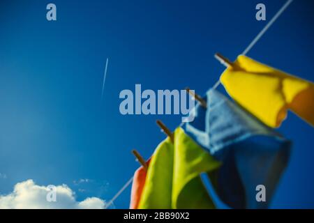 Blue skies with colourful laundry hanging Stock Photo