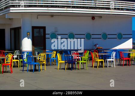 Colorful empty chairs ready for outside diners Stock Photo