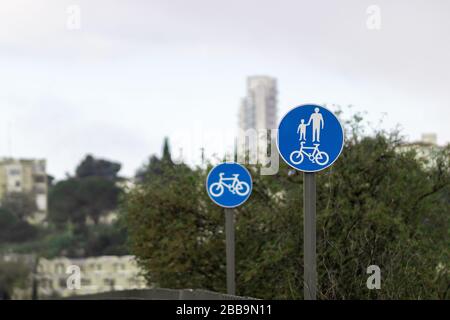 Blue Road Signs, Israel - Pedestrian and Cyclist Trail. Trees and buildings background Stock Photo