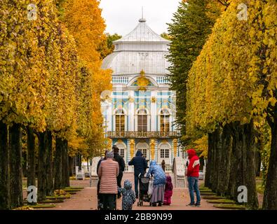 Tourist walking in Catherine Park in Autumn to Hermitage Pavilion, Tsars Village, Tsarskoe Selo, Pushkin, Russian Federation Stock Photo
