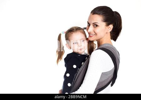 Mother and toddler child in woven wrap baby carrier Stock Photo