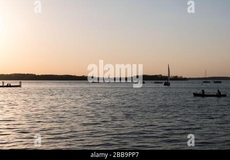 MADISON, WISCONSIN - MAY 07, 2018: Silhouette view of people canoeing on Lake Mendota. Stock Photo