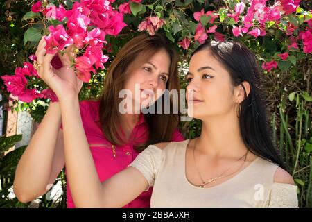 A middle aged cuban mother out in the garden with her beautifull young daughter. Stock Photo