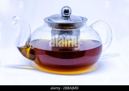 A glass tea pot with tea isolated on a white background. Stock Photo