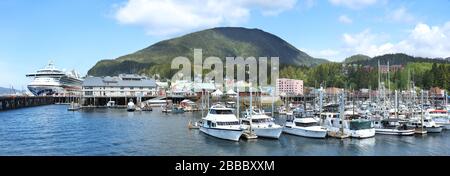 Thomas Basin which provides moorage for various water crafts and fishing boats in Ketchikan, Alaska, U.S.A. On the left is the berthing area for cruise ships. Stock Photo