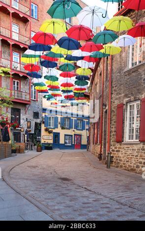 Several dozen multicoloured umbrellas suspended above rue du Cul-de-Sac (Dead End St.) in the Lower Town of Old Quebec City, Quebec, Canada