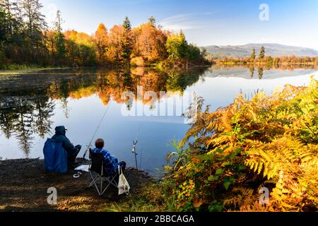 Fishermen at the edge of Dougan Lake in Cobble Hill, British Columbia. Stock Photo