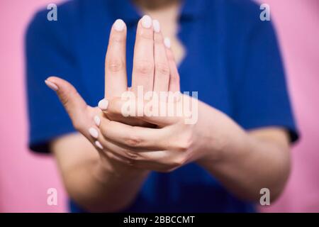 Woman feeling hand and wrist pain. Carpal tunnel syndrome. Female with finger, hand and wrist problems Stock Photo