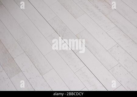 Ceramic wood effect tiles and tools for tiler on the floor  unfinished laying floor tiles  Floor tiles installation Stock Photo