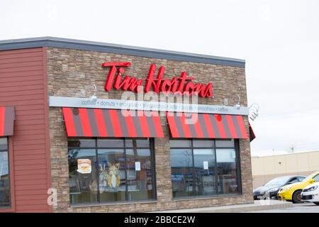 Close up of a sign showing Tim Hortons fast food restaurant building. Tim Hortons is Canada's largest restaurant chain.