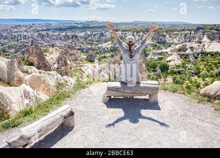 Happy Young woman with rising hands in Goreme valley in Cappadocia, Turkey Stock Photo