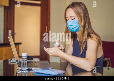 Coronavirus. Young business woman working from home wearing protective mask and uses a sanitizer gel. Business woman in quarantine for coronavirus Stock Photo