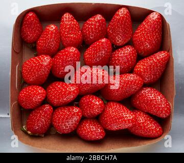 punnet strawberries overhead brown cardboard fresh summer fruits juicy succulent washed clean portion Stock Photo