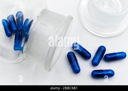 Blue medicine pils isolated on white background. Stock Photo