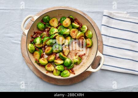 cooked Brussel sprouts bacon pan overhead browned kitchen tea towel Christmas lunch traditional seasonal Stock Photo