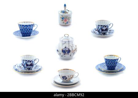 Collection of porcelain tea cups and dishes with flower ornament. Full size. Stock Photo