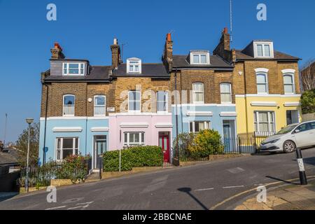 LONDON, UK - 27TH MARCH 2020: Colourful buildings along Point Hill in Greenwich. The exteriors can be seen painted in different colors. Stock Photo