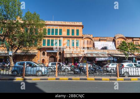 JAIPUR, INDIA - 23RD MARCH 2016: The outside of buildings in the Pink City (Old City) of Jaipur. Traffic, people and shops can be seen as well as colo Stock Photo