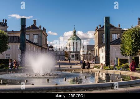 Water fountain in Amaliehaven or Amalie Gardens on waterfront with Amalienborg (Royal Palace) and Marble Church in Copenhagen Denmark Stock Photo