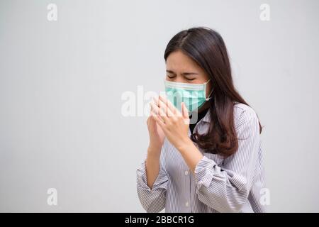 Portrait of a sick flu young woman asian wearing medical mask. Pandemic 2019 Coronavirus 2019-nCoV Concept. Stock Photo