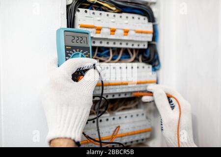 Electrician installing or repairing apartment electrical panel, close-up view Stock Photo