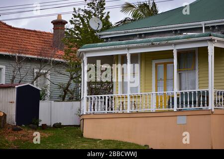 Old wooden house with front porch under corrugated metal roof. Stock Photo