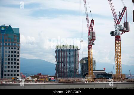 Construction cranes in downtown Vancouver, British Columbia, Canada Stock Photo