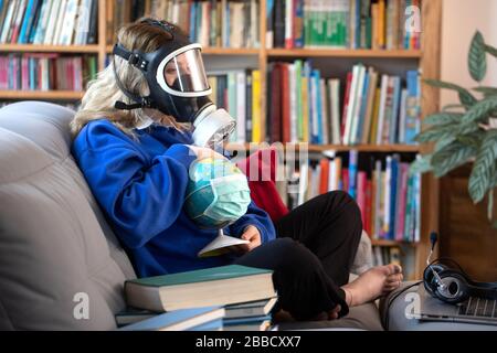 girl holding the planet earth is wearing a protective mask. Concept of quarantine, protection from viruses and pandemic Stock Photo