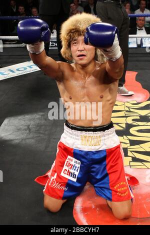 Choi Tseveenpurev (red/blue shorts) defeats Janis Purkins in a Featherweight boxing contest at York Hall, Bethnal Green, promoted by Spencer Fearon / Stock Photo