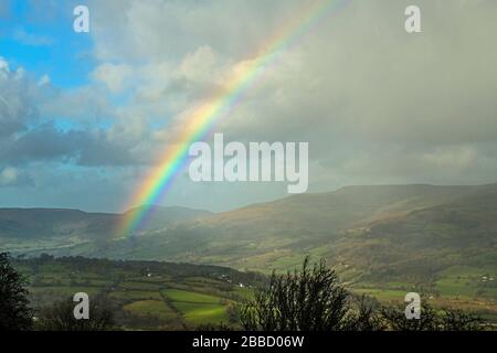 A rainbow high over the Usk Valley in the Brecon Beacons National Park in January Stock Photo