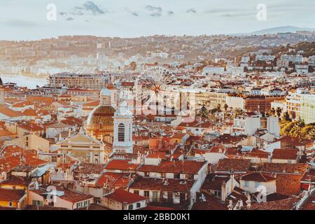 scenery panoramic aerial city scape view of Nice, France. red roofs, big ferris wheel, harbor, houses, church and architecture in Nice. Cote d'Azur Stock Photo