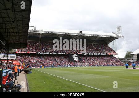 General view as a banner bearing the face of Billy the Puppet from the Saw movies is held in the stands at Selhurst Park Stock Photo