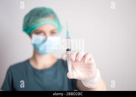 Female doctor nurse with syringe in hands with vaccine medicine Stock Photo