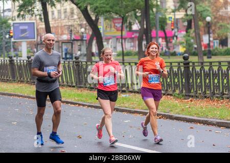 DNIPRO, UKRAINE - SEPTEMBER 16, 2018: Group of happy and smiling participants running during 21 km distance of ATB Dnipro Marathon race Stock Photo