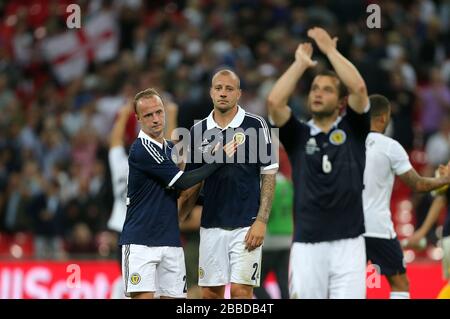 Scotland's Alan Hutton (centre) and teammate Leigh Griffiths  look dejected after the final whistle Stock Photo