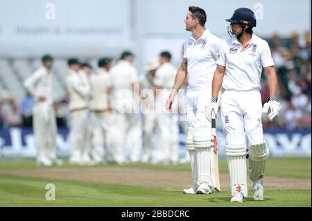 England's Alastair Cook walks off the pitch after being caught out from the bowling of Mitchell Starc Stock Photo