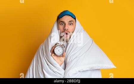 Young man does not want get up for work Stock Photo