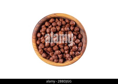 Top view of chocolate balls in wooden bowl. Close up photo. Childrens fast breakfast. Isolated on white background. Stock Photo