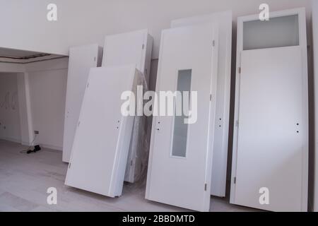 Interior doors stacked in a new apartment waiting for installation Stock Photo