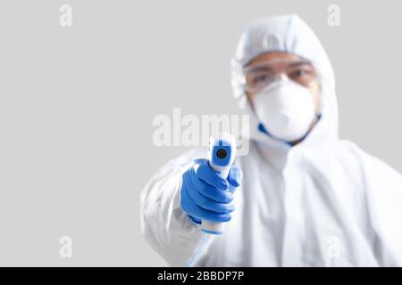 Asian man doctor measure temperature infrared thermometer Stock Photo