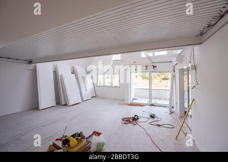 Interior doors stacked in a new apartment waiting for installation Stock Photo