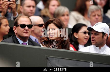 Mirka Federer watches her husband, Roger, on Centre Court Stock Photo