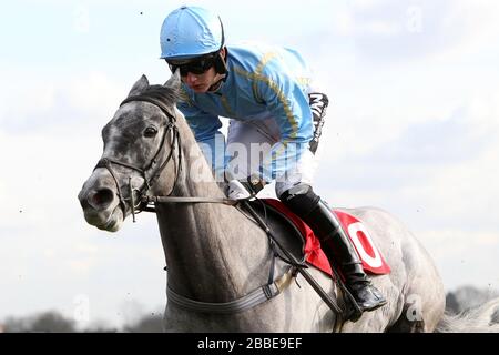 Thundering Home ridden by Tom Bellamy in action in the Kempton.co.uk Conditional Jockey's Handicap Hurdle - Horse Racing at Kempton Park Racecourse Stock Photo