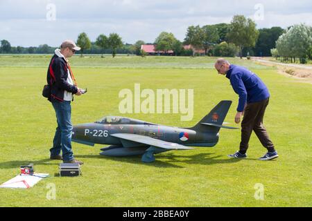 NIJVERDAL, NETHERLANDS - JUNE 23, 2018: Unknown people busy with a remote controled jet during a demonstration Stock Photo